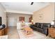 Spacious living room with leather couches and a tiled floor at 7345 Shelduck St, North Las Vegas, NV 89084