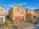 Two-story house with red garage door and landscaped yard at 9218 Brayden Bay St, Las Vegas, NV 89178