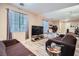 Open living area with tile floors and a brown couch at 9790 Overlook Ridge Ave, Las Vegas, NV 89148