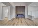 Modern living room featuring a linear fireplace and wood-look floors at 10000 Arbuckle Dr, Las Vegas, NV 89134