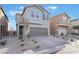 Two-story house with gray exterior, brown garage door, and paved driveway at 10152 Midnight Onyx St, Las Vegas, NV 89141