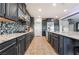 Modern kitchen with granite countertops and dark cabinetry at 1025 Bluebird Hill Ave, North Las Vegas, NV 89084