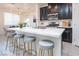 Modern kitchen with dark cabinetry, white countertops, and island with seating at 12540 Mosticone Way, Las Vegas, NV 89141