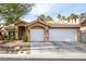 Two-car garage and mature landscaping at 1605 Shadow Rock Dr, Las Vegas, NV 89117