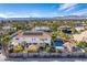 Aerial view of a house, pool, and surrounding neighborhood with mountain views at 2108 Grand Island Ct, Las Vegas, NV 89117