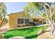 Landscaped backyard with artificial turf and a large covered patio at 2154 Colvin Run Dr, Henderson, NV 89052