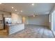 Open concept kitchen with island, gray cabinets, and granite countertops at 4538 Solitude Falls Ave, North Las Vegas, NV 89084