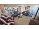 Living room with gray sofas, a striped chair and kitchen view at 4717 S Maddington Ct, Pahrump, NV 89061