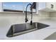 Modern kitchen sink with a sleek, black gooseneck faucet at 491 Kristin Ln, Henderson, NV 89011