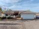 House exterior with landscaping and a white garage door at 520 Belville Rd, Pahrump, NV 89048