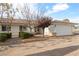 House exterior with landscaping and a white garage door at 520 Belville Rd, Pahrump, NV 89048