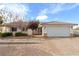 One-story home featuring a two-car garage and manicured landscaping at 520 Belville Rd, Pahrump, NV 89048