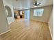 Living room with laminate flooring, kitchen view, and ceiling fan at 5255 Cedar Bend Dr, North Las Vegas, NV 89031