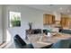 Modern dining room with chevron patterned table and kitchen view at 6009 Silvalde Ln, Las Vegas, NV 89135