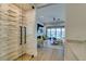 Modern wine cellar with glass door and built-in wooden shelving at 6009 Silvalde Ln, Las Vegas, NV 89135