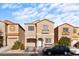 Two-story tan house with a two-car garage and landscaping at 6122 Walker Valley Ct, Las Vegas, NV 89139