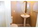 Small bathroom with pedestal sink, toilet and oval mirror at 6365 Black Swan Ln, Las Vegas, NV 89118