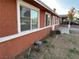 Side view of a red brick ranch home with white trim and landscaping at 6529 Bourbon Way, Las Vegas, NV 89107