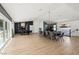 Open concept dining area with a large table and modern chandelier at 6971 Arville St, Las Vegas, NV 89118