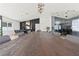 Long wooden dining table with seating for many guests in a bright room at 6971 Arville St, Las Vegas, NV 89118