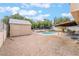 Backyard with pool, patio, and storage shed at 7009 Rawlins Ct, Las Vegas, NV 89128