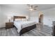 Main bedroom with ceiling fan, wood-like floors and ensuite bathroom at 7009 Rawlins Ct, Las Vegas, NV 89128