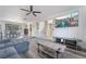 Open concept living area with gray sectional and wood-look floors at 7009 Rawlins Ct, Las Vegas, NV 89128