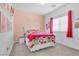 Bright bedroom with pink walls, a queen bed, and window coverings at 7026 Calvert Cliffs St, North Las Vegas, NV 89084