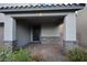 Covered front porch with stone accents and a dark-colored front door at 7097 Range Valley St, North Las Vegas, NV 89084