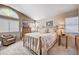 Bright bedroom with brass bed frame and sitting area at 7166 Cloud View Cir, Las Vegas, NV 89119