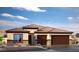 One-story home with brown double garage doors and a terracotta tile roof at 7535 Phoenix Falls St # Lot 52, North Las Vegas, NV 89084