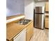 Kitchen boasts stainless steel refrigerator and double sink at 8250 N Grand Canyon Dr # 2092, Las Vegas, NV 89166