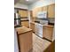 Modern kitchen featuring stainless steel refrigerator and light wood cabinets at 8250 N Grand Canyon Dr # 2092, Las Vegas, NV 89166