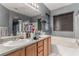 Bathroom with double sinks, a bathtub, and a walk-in shower at 8905 Cambridge Glen Ct, Las Vegas, NV 89149