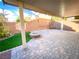 Covered patio with firepit and artificial turf at 10841 Hunters Green Ave, Las Vegas, NV 89166