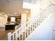 Modern white staircase leading to upper level with kitchen view at 10841 Hunters Green Ave, Las Vegas, NV 89166