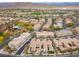 Aerial view of a residential community showing a multi-Gathering home near a golf course and mountains at 11347 Belmont Lake Dr # 101, Las Vegas, NV 89135