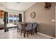 Kitchen dining area with wood table and patterned chairs, adjacent to sliding glass doors at 1291 Bunnell Ave, Logandale, NV 89021