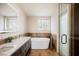 Elegant bathroom featuring a soaking tub and double vanity at 1312 Alderton Ln, Las Vegas, NV 89144