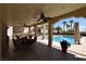 Covered patio with seating area overlooking the refreshing pool at 1655 Stonehill Rd, Las Vegas, NV 89156