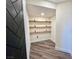 Built-in shelving with dark wood accents and herringbone door at 2250 Shaw Cir, Las Vegas, NV 89117