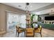 Elegant dining room with round table, yellow chairs, and view of backyard at 3091 E Rampoldi Rd, Las Vegas, NV 89141