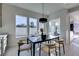 Bright dining area with large windows and modern table at 3423 Spanish Winds Ct, Las Vegas, NV 89141