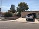 Exterior view of house with a truck in the driveway and a city view in the background at 4483 Via San Marco, Las Vegas, NV 89103