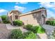 Tan house with walkway, landscaping, and garage at 5053 Vincitor St, Las Vegas, NV 89135