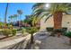 Relaxing patio area with picnic tables and palm trees at 5301 River Glen Dr # 210, Las Vegas, NV 89103