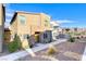 Two-story townhome with stone accents and yellow door at 545 Carmel Point Ct, Henderson, NV 89044