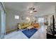 Open living space with yellow sofa and dining area at 545 Carmel Point Ct, Henderson, NV 89044