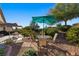 Patio with seating area, umbrella, and desert landscaping at 565 Fairways Dr, Mesquite, NV 89027