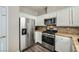 Bright kitchen, featuring stainless steel appliances and granite countertops at 61 Tahiti Dr, Henderson, NV 89074